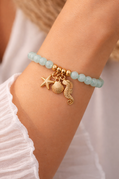 Armband elastisch Helltürkis Hellblau Anhänger Muschel Seestern Seepferdchen Biba